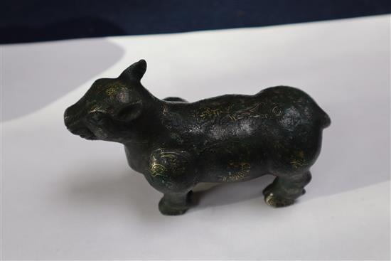 A Chinese gold and silver inlaid bronze figure of a tapir, Han dynasty or later, L. 12cm, excluding hardwood stand and fitted box